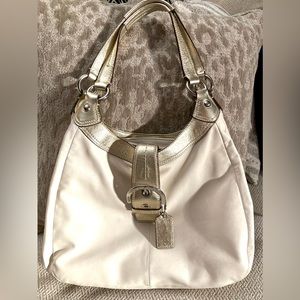 New medium size Coach purse. Cream color with gold accent and lavender interior.